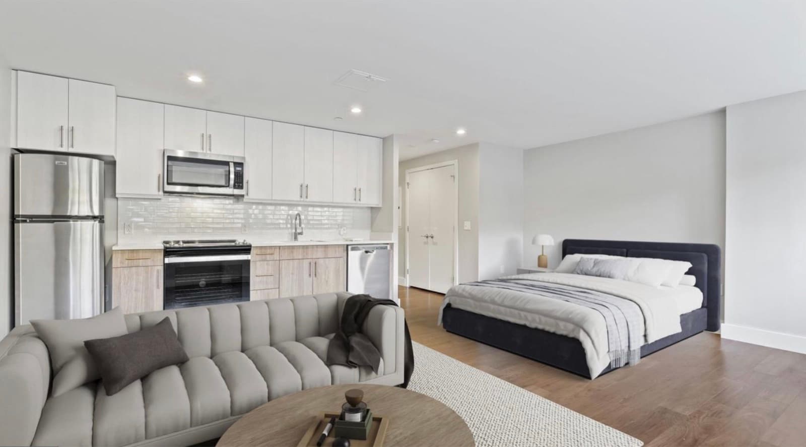 Studio layout with kitchen and bed