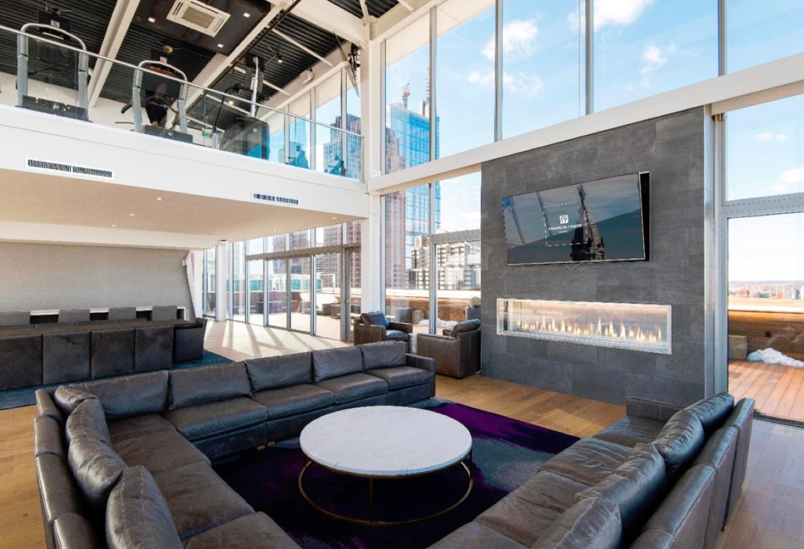 Two-story resident lounge with fireplace