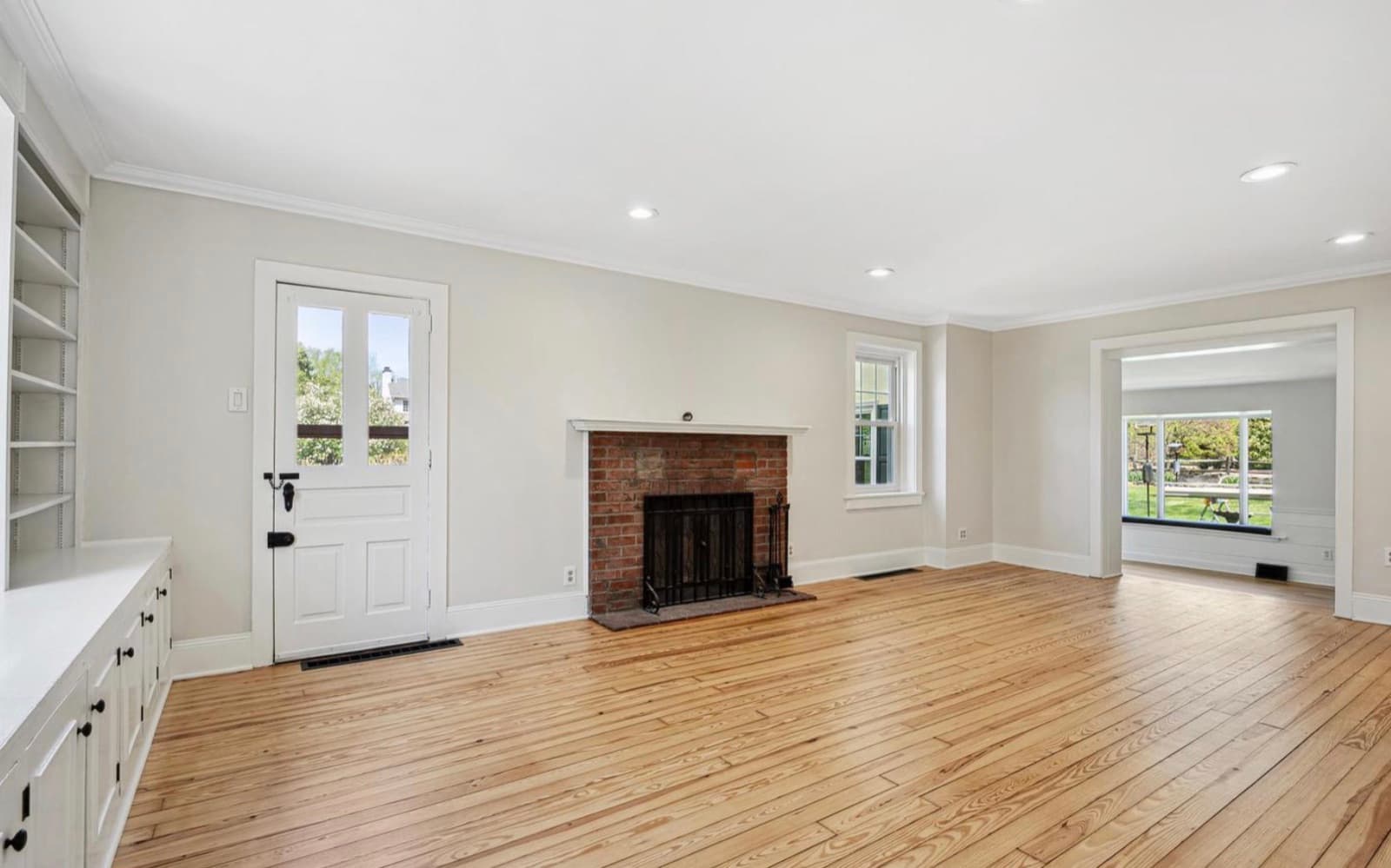 Living room with brick fireplace and built-ins