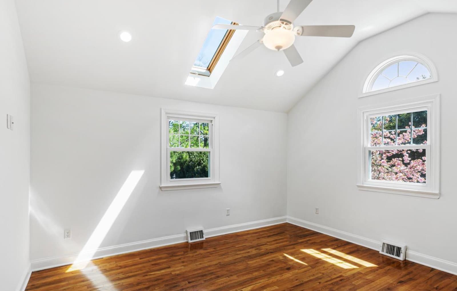 Bedroom with vaulted ceiling and skylight