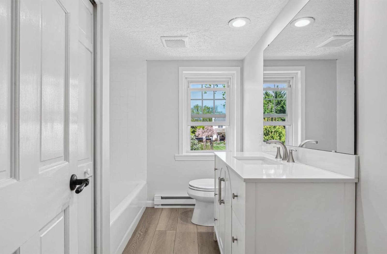Full bathroom with vanity and tub