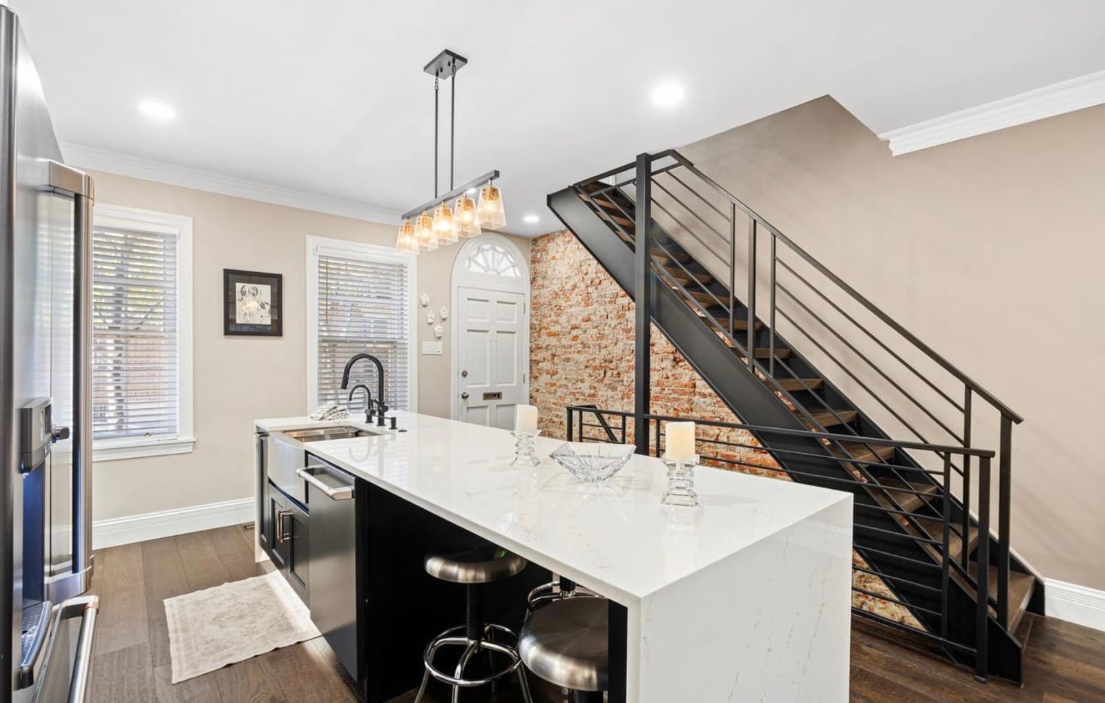 Kitchen with marble island and open staircase
