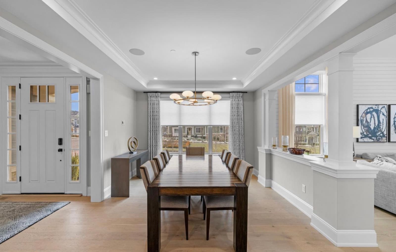 Dining room with chandelier and front door view