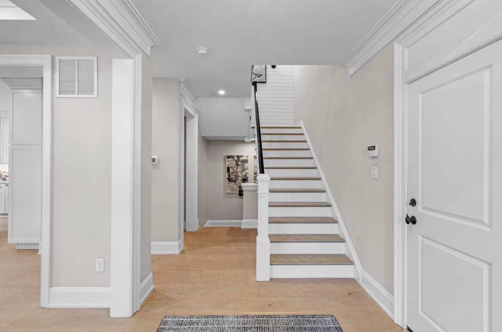 Foyer with white staircase